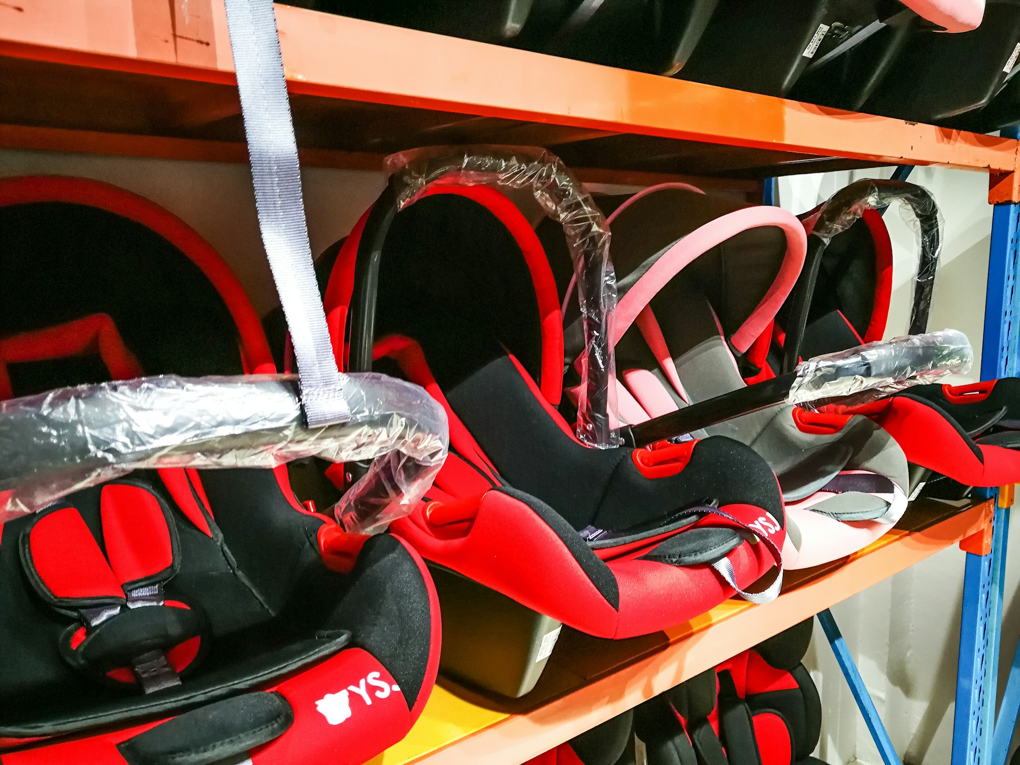 baby carseat in red colour display at the shop