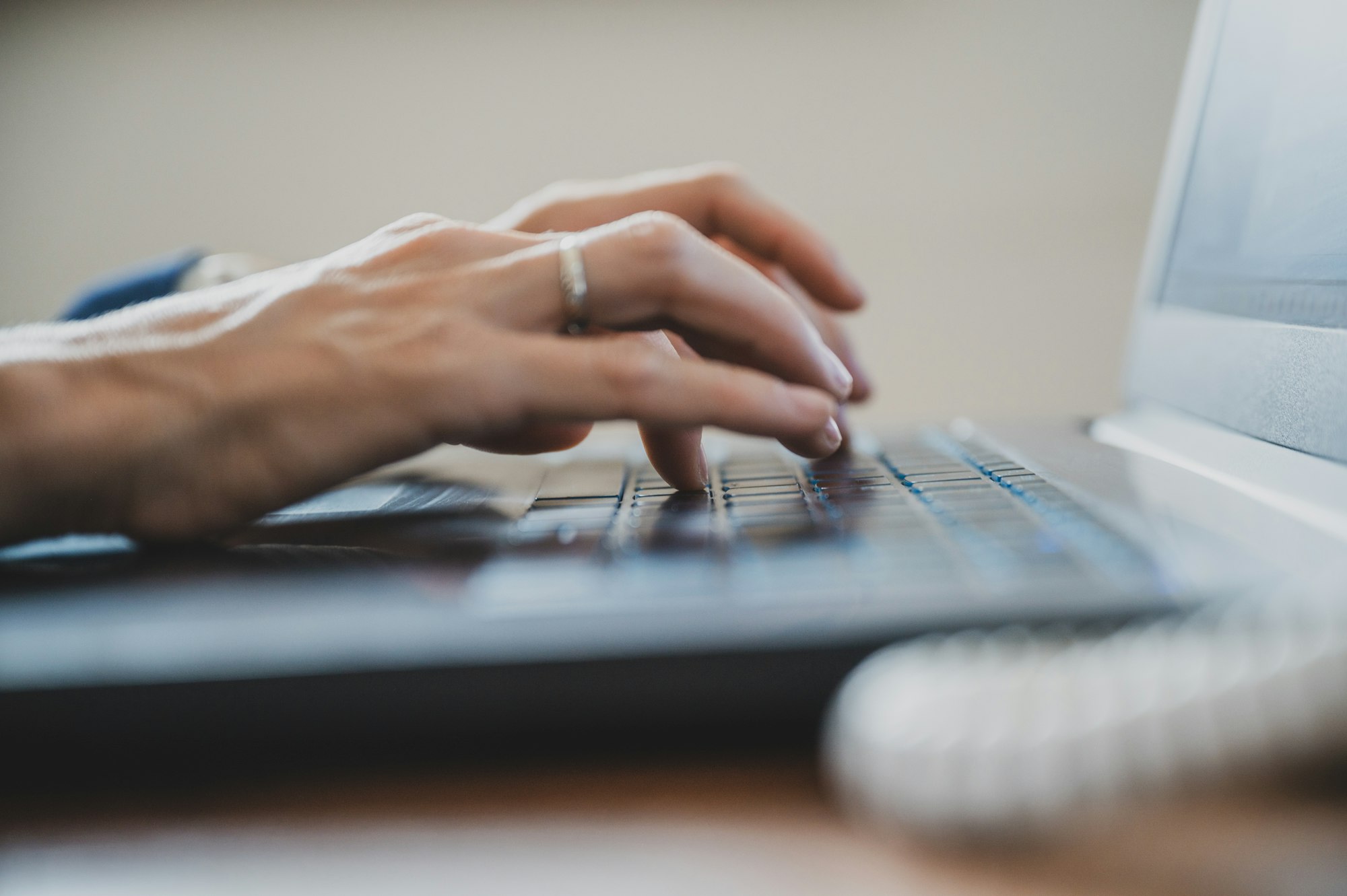 Low angle view of female hand using laptop computer